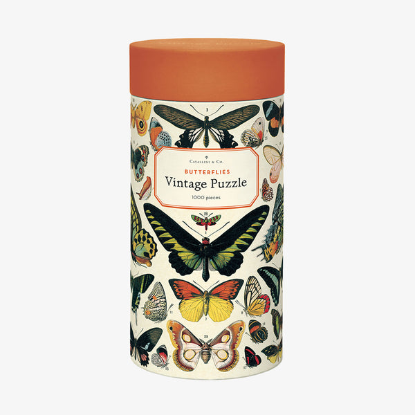 Cavallini Paper Butterflies Puzzle in round tube with orange top and butterfly illustrations on a white background