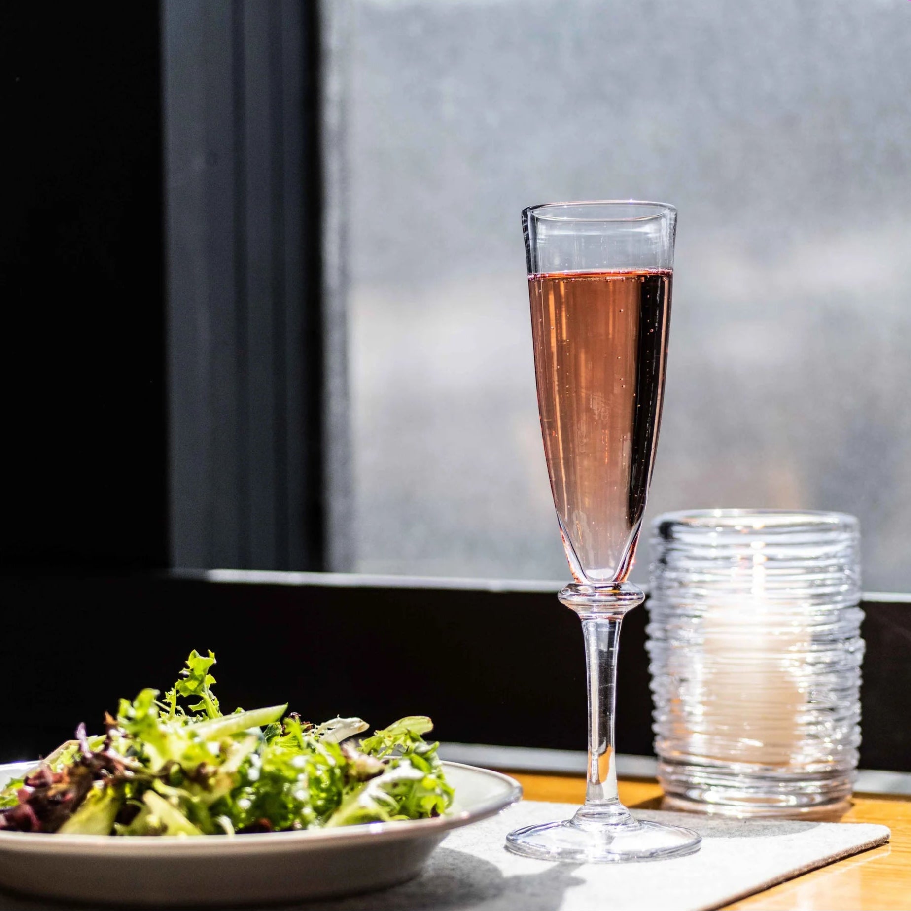 Simon Pearce Cavendish Champagne Flute on a table at Addison West