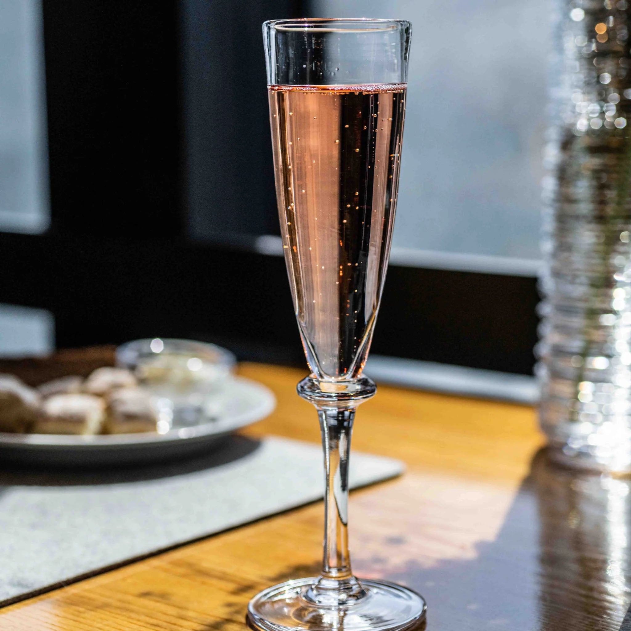 Simon Pearce Cavendish Champagne Flute on a table at Addison West