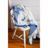 Chappy Wrap First Tracks Blanket on a white chair in a room with a wood floor