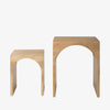 Set of two mangowood nesting tables with arch cut out on a white background