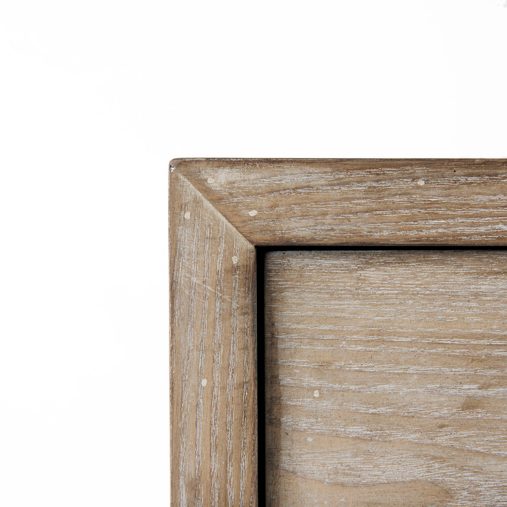 Cabinet with two drawers in white washed wood and black metal base on a white background