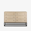 White washed wood six drawer dresser with metal base on a white background