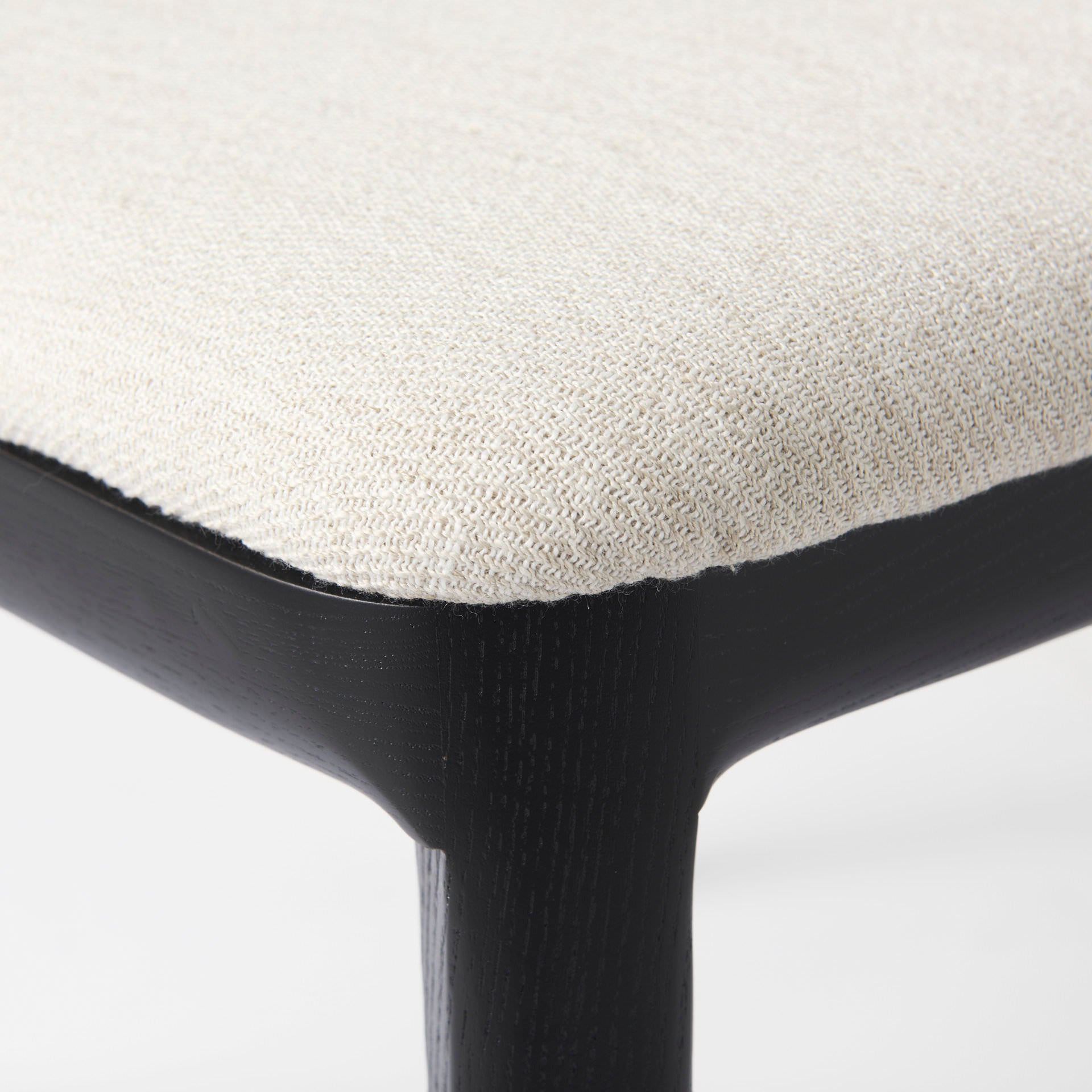 Clara Black Wood W/ Cream Fabric Seat and Cane Back Armless Dining Chair on a white background