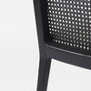 Close up of Clara Black Wood W/ Cream Fabric Seat and Cane Back Armless Dining Chair on a white background