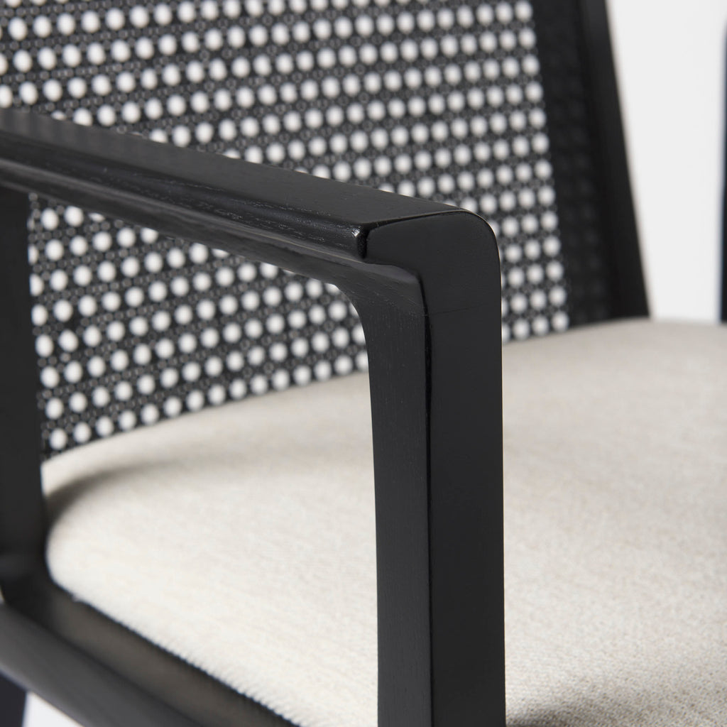 Close up of Clara Black Wood W/ Cream Fabric Seat and Cane Back Dining Chair on a white background