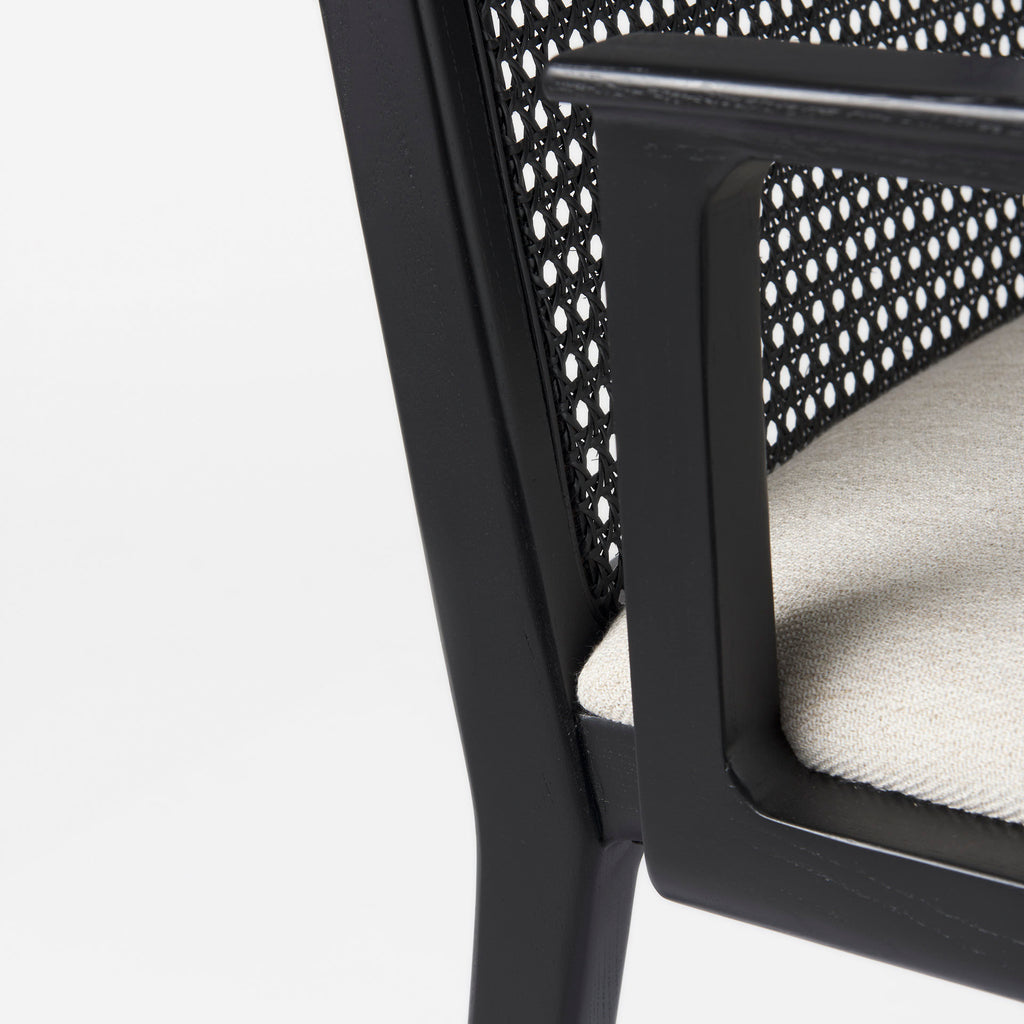 Close up of Clara Black Wood W/ Cream Fabric Seat and Cane Back Dining Chair on a white background
