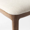 Close up of Clara Light Brown Wood W/ Cream Fabric Seat and Cane Back Armless Dining Chair on a white background