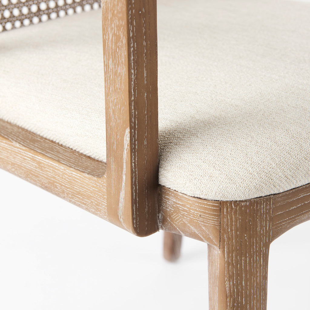 Close up of Clara Light Brown Wood W/ Cream Fabric Seat and Cane Back Dining Chair on a white background