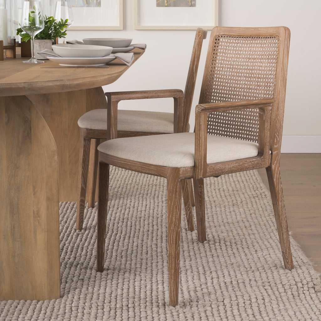 Clara Light Brown Wood W/ Cream Fabric Seat and Cane Back Dining Chair at a dining table