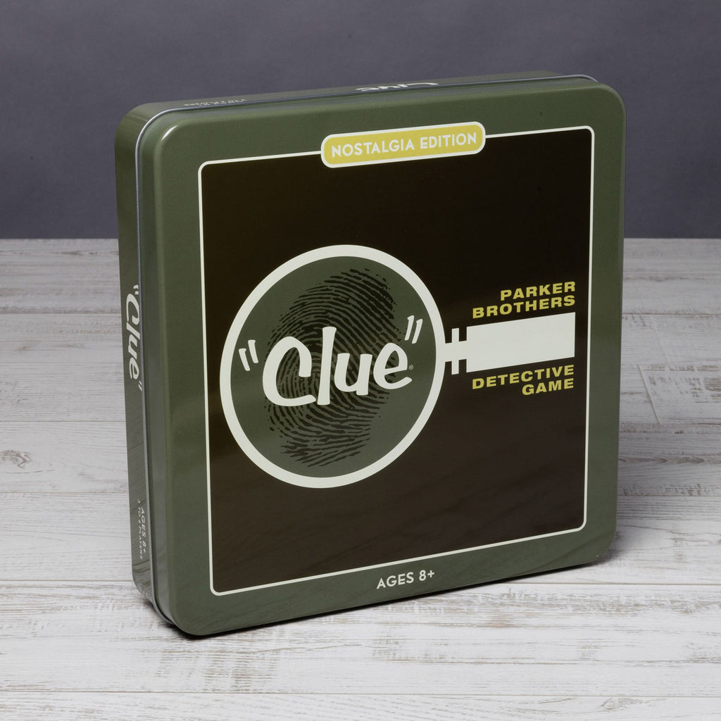 Green and black Clue game tin on a white wood surface