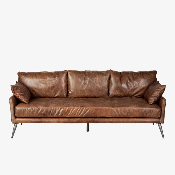 Mercana brand cochrane II three seater brown leather sofa with metal legs on a white background