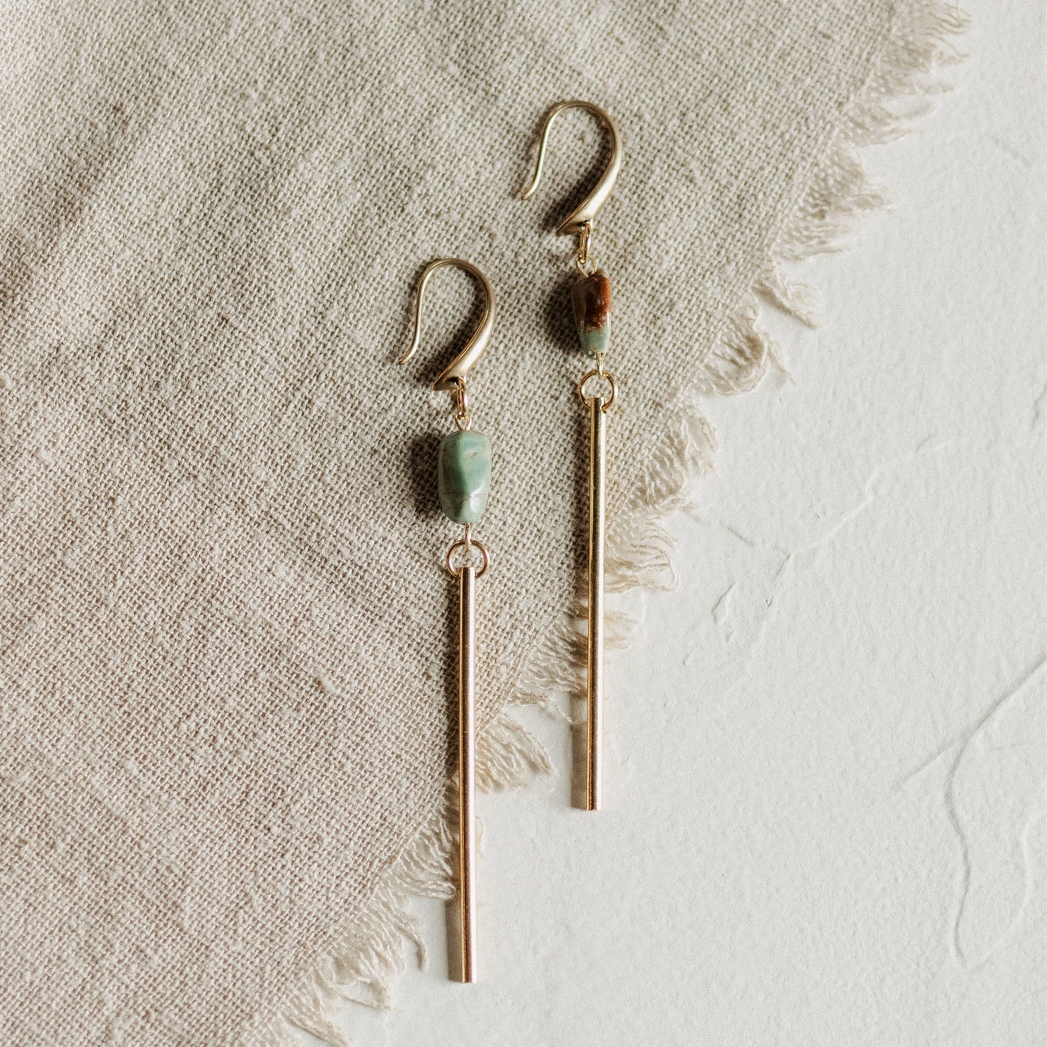 Commonform Passerine Earrings in Turquoise on textured background at the Addison West.