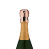 Copper Champagne Stopper by Viski a champagne bottle on white background