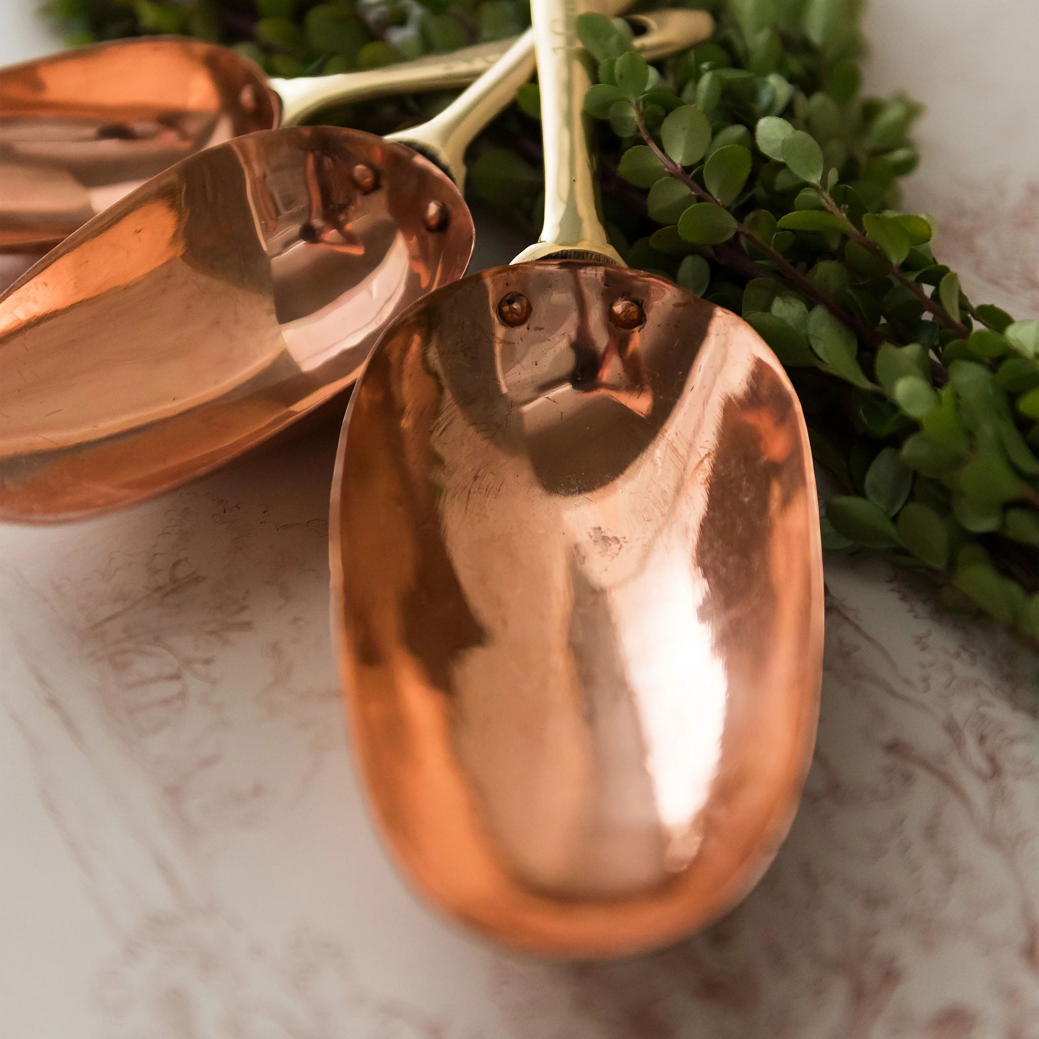 Copper Measuring Scoops on a table at Addison West