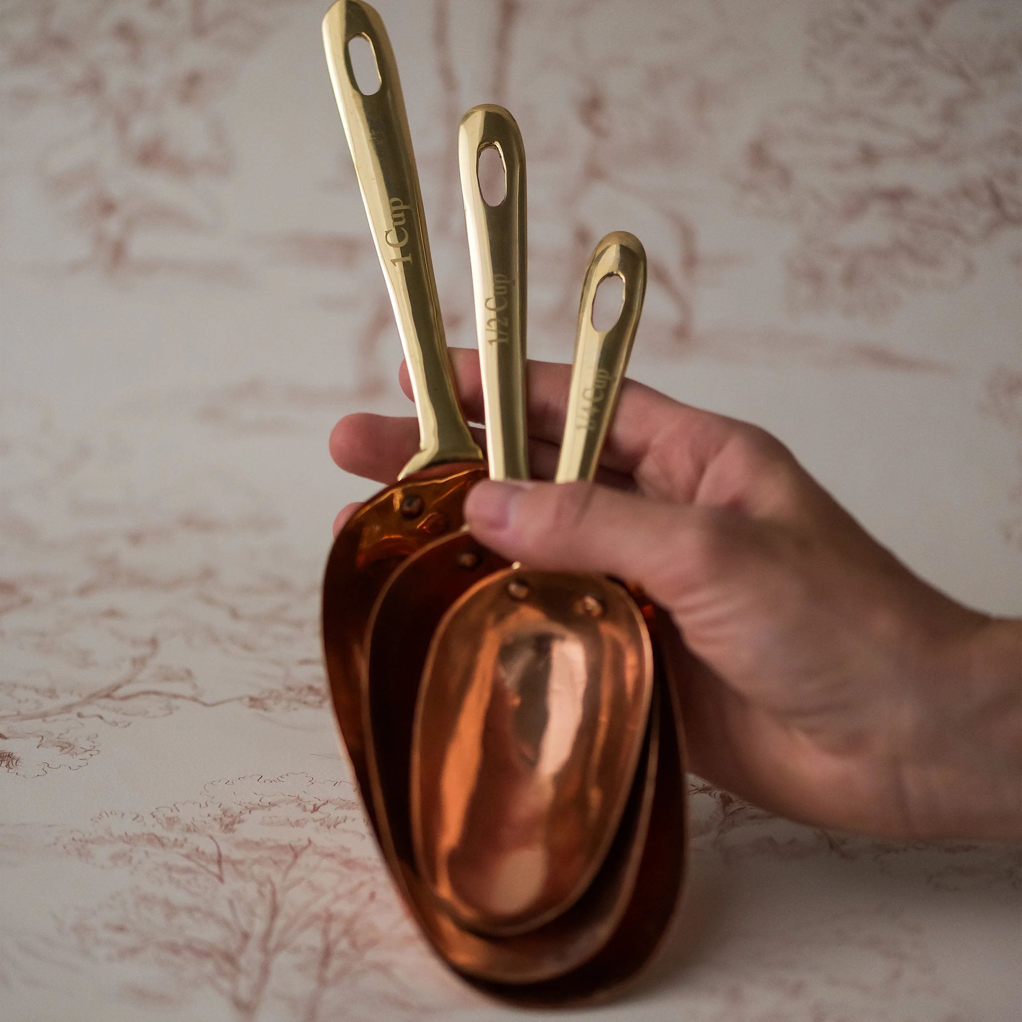 Copper Measuring Scoops on a table at Addison West