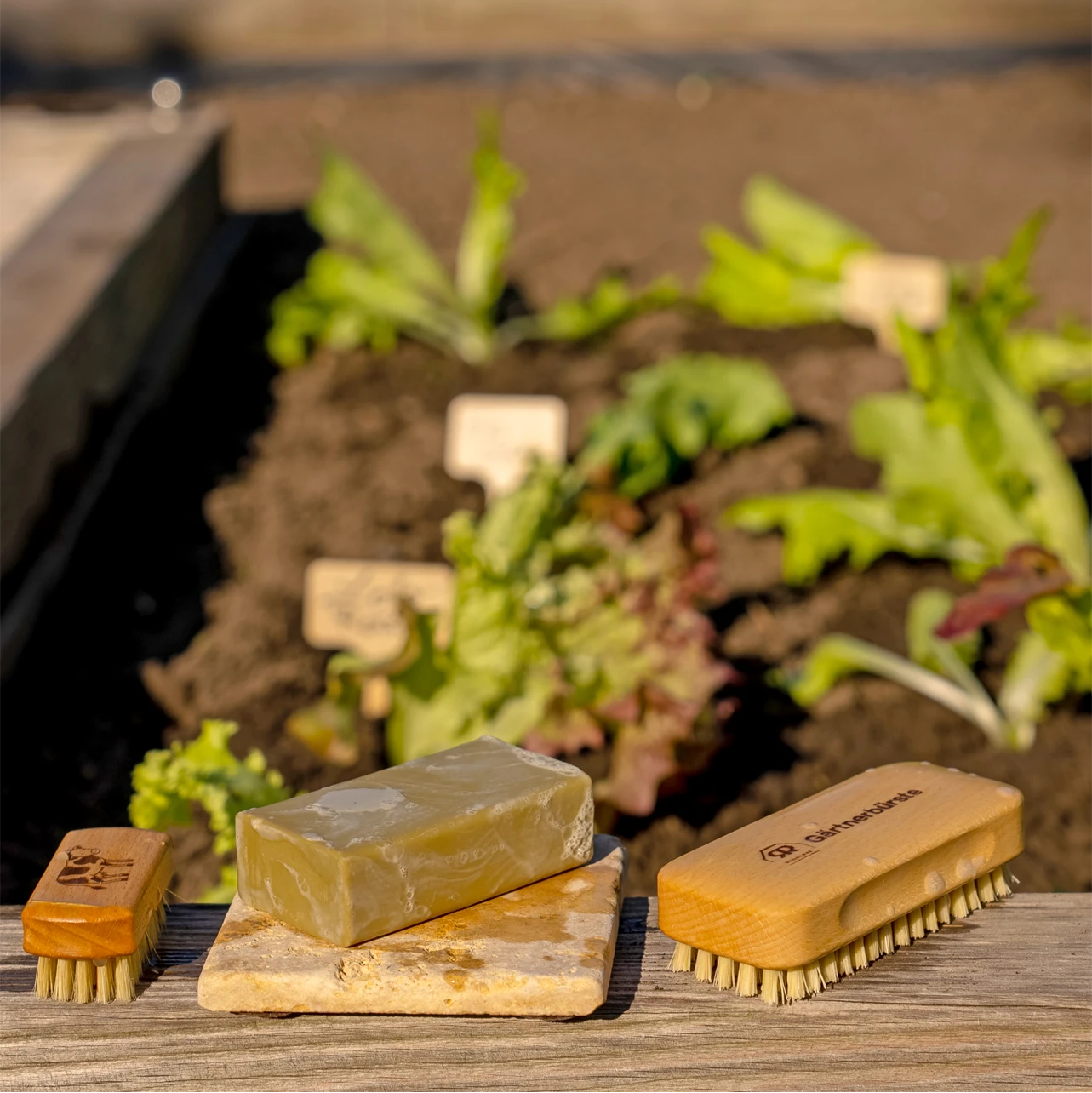 Redecker Gardener's Nail Brush with a garden in the background at Addison West