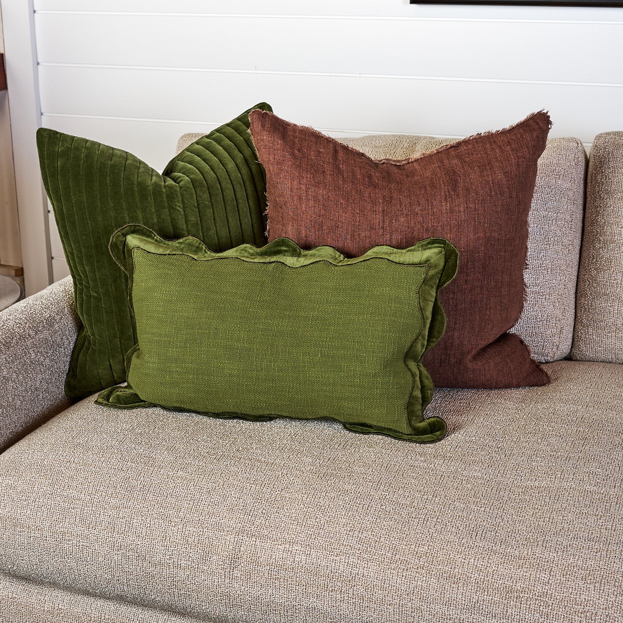 Velvet Scallop Lumbar Pillow in Moss on a sofa at Addison West