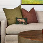 Moose Hand Hooked Pillow on a sofa at Addison West