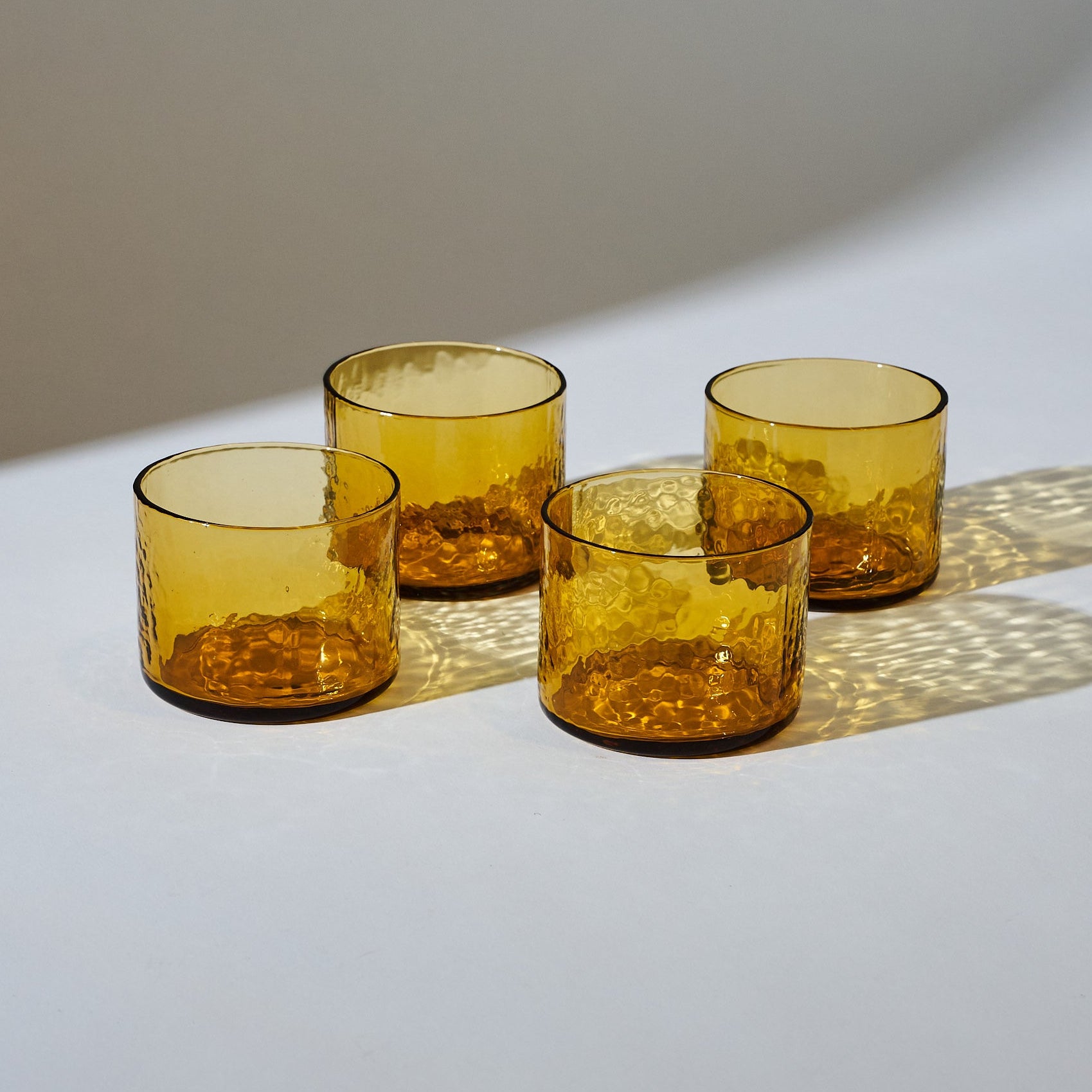 Hammered Amber Drinking Glass on a white background at Addison West