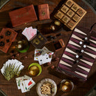 Collection of unique wood and leather games on a dark wood coffee table at Addison West