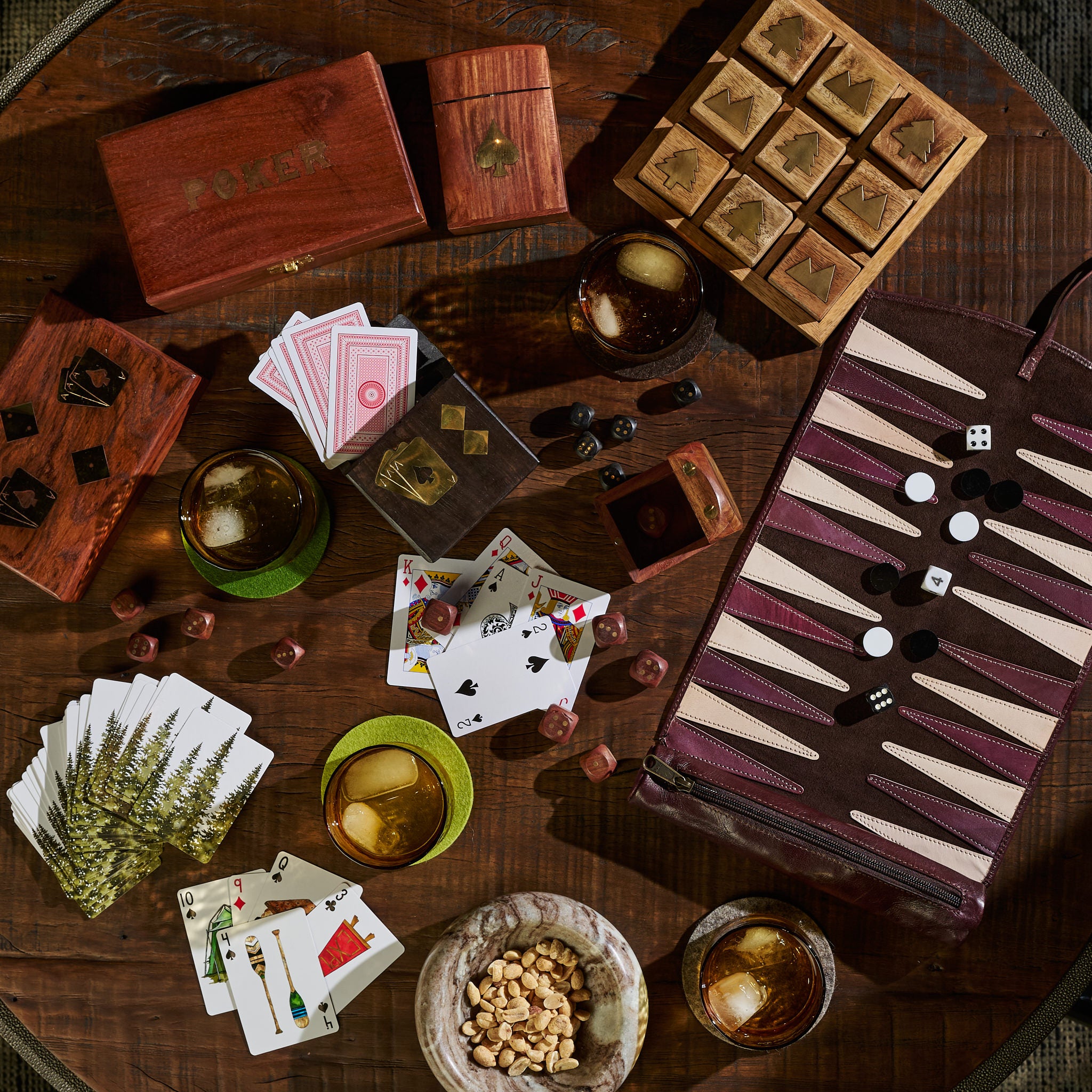 Collection of unique wood and leather games on a dark wood coffee table at Addison West