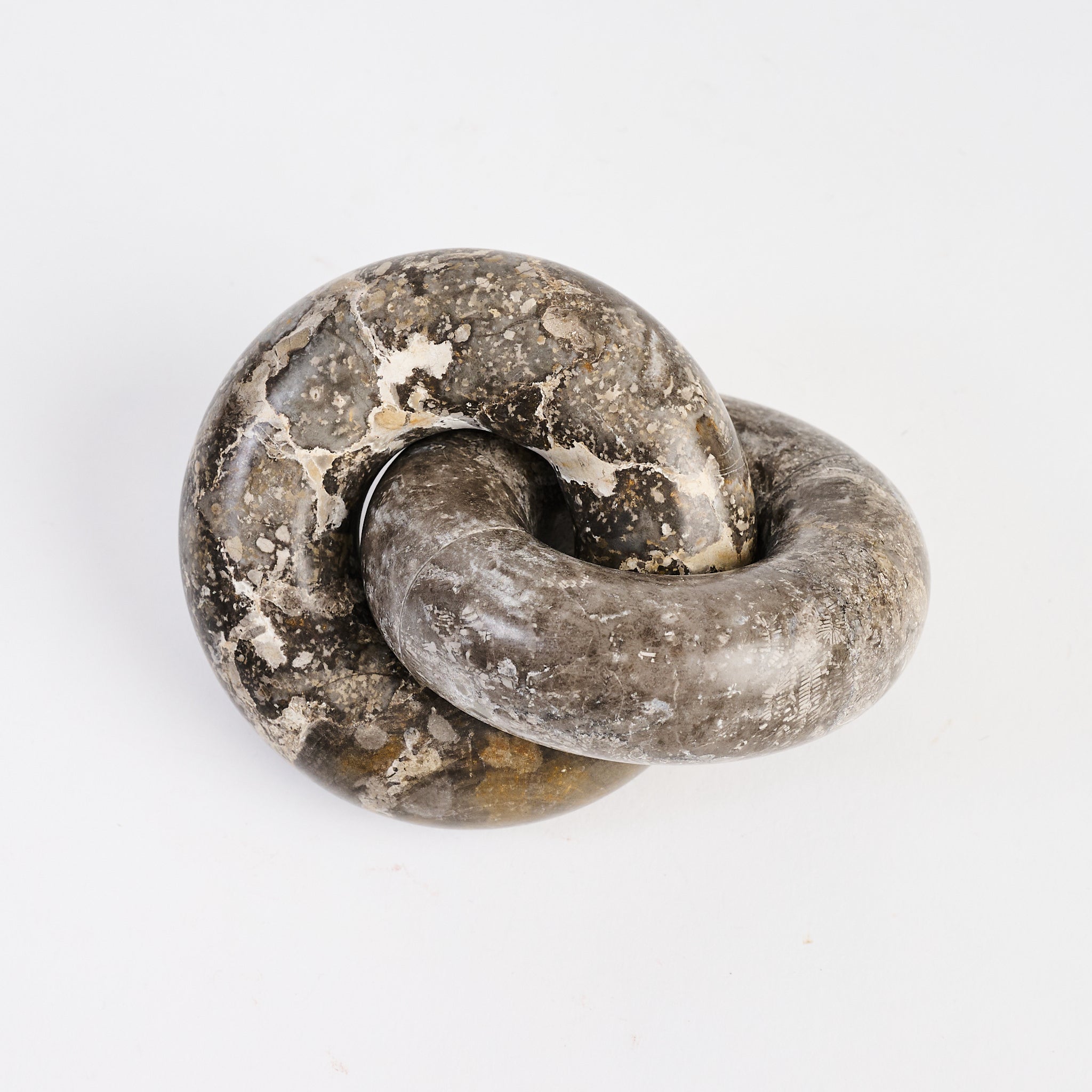 Marble Links Sculpture on white background at Addison West.