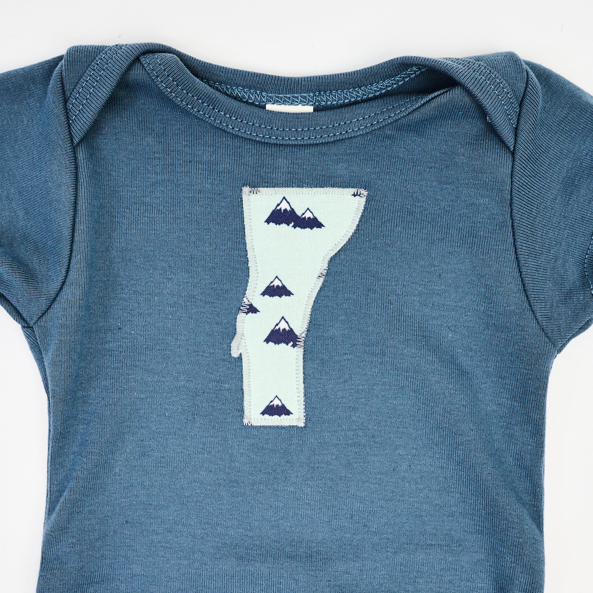 Vermont Baby Blue Bodysuit in Blue Mountains on a white background at Addison West