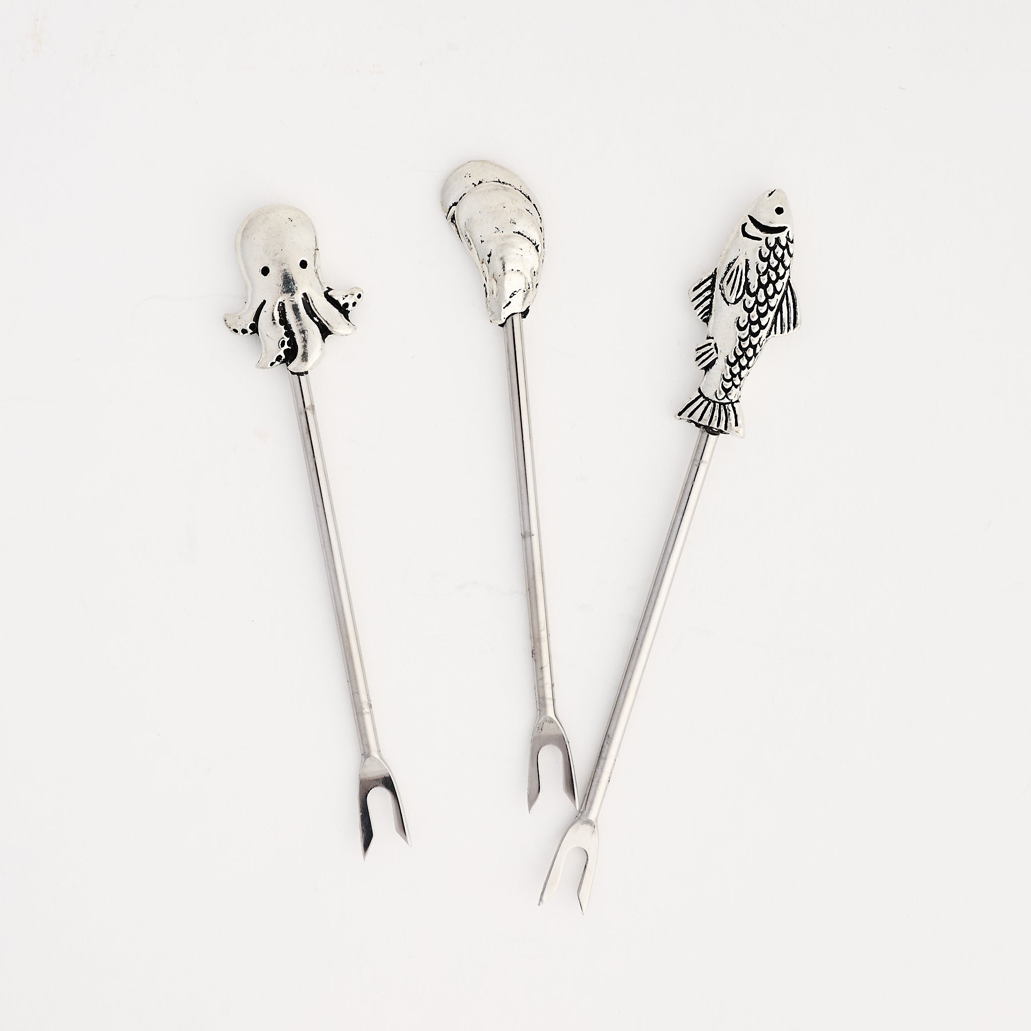 Pewter Fish, oyster, and octopus Hors d'Oeuvre Pick on a white background at Addison West