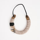 Upcycled Lucky Horseshoe in Beige Feather on a white background at Addison West