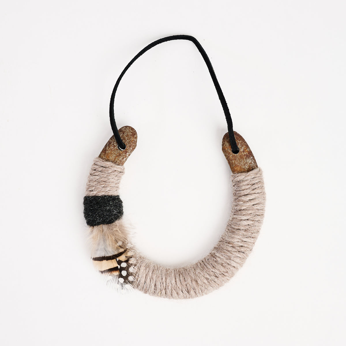 Upcycled Lucky Horseshoe in Beige Feather on a white background at Addison West