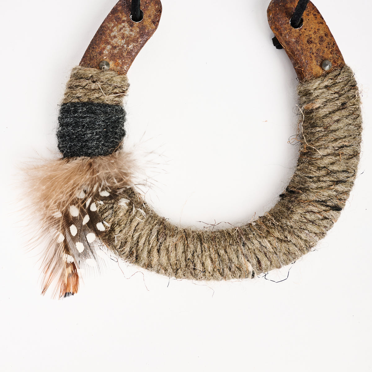 Upcycled Lucky Horseshoe in Brown Feather on a white background at Addison West