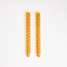Greentree 10" Rope Taper Candle in Goldenrod on a white background at Addison West
