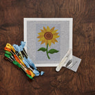 Sunflower Needlepoint Kit on a wood table at Addison West