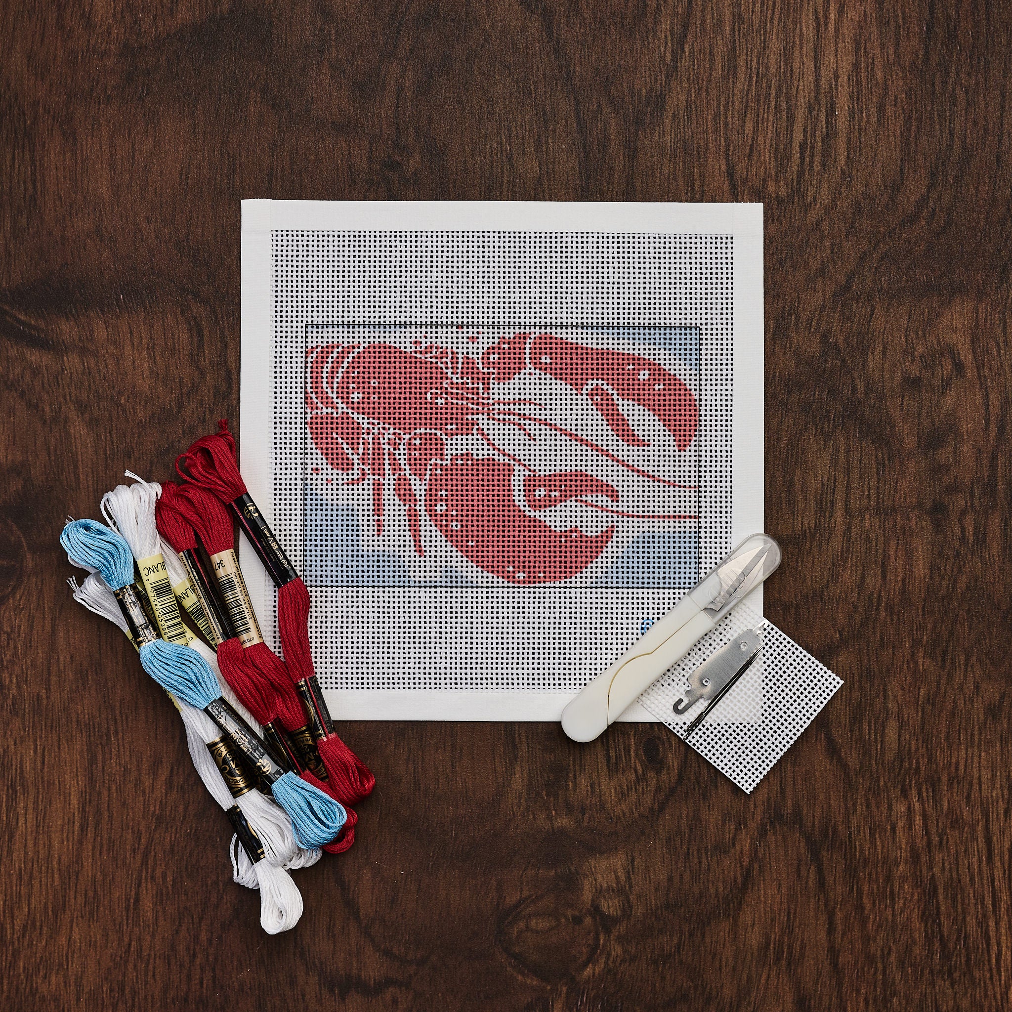 Lobster Needlepoint Kit on a wood table at Addison West