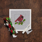 Cardinal with Holly Needlepoint Kit on a wood table at Addison West
