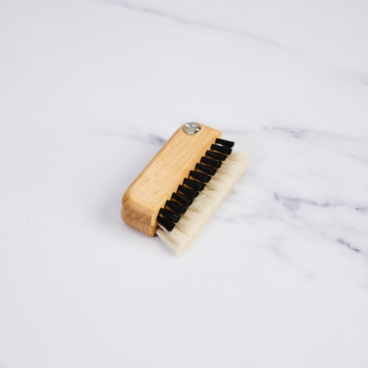 Redecker Laptop Brush on a marble table at Addison West