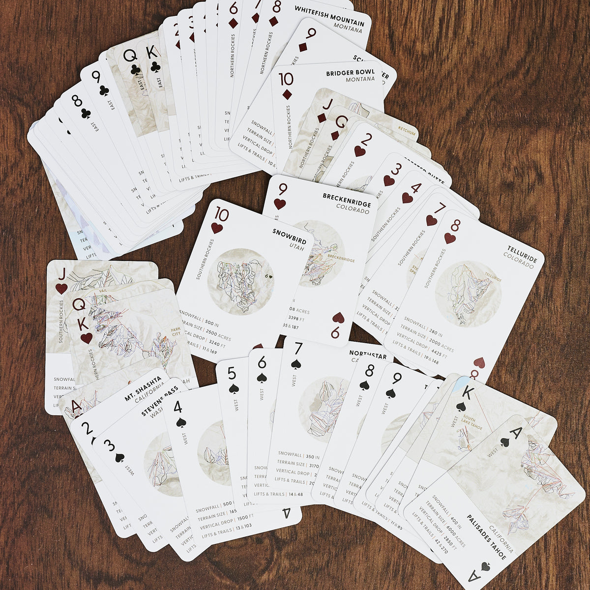 Ski the States Playing Cards on a wood table at Addison West