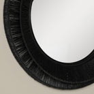 Close up of Collins Small Jute Mirror in Black on a beige background at Addison West
