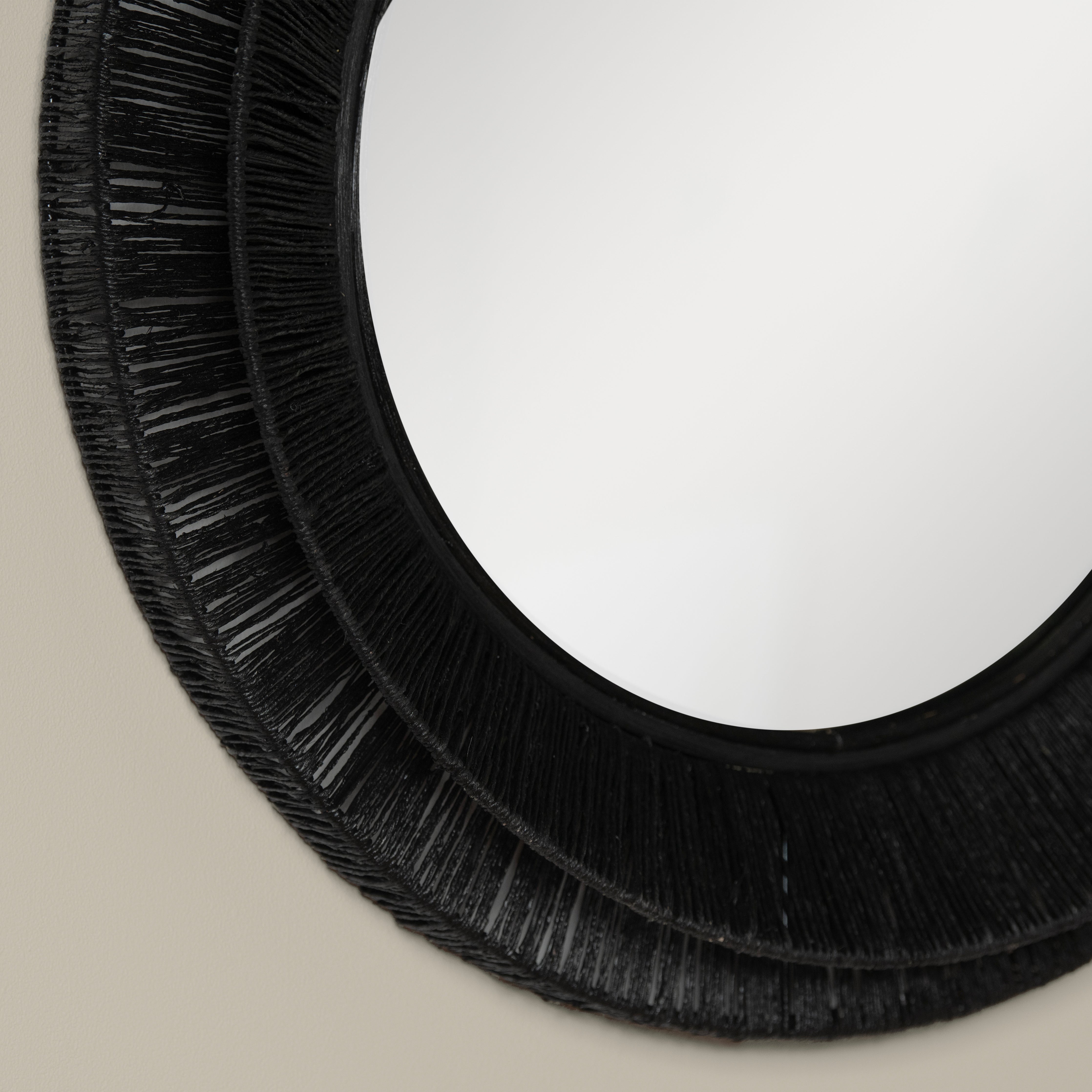Close up of Collins Small Jute Mirror in Black on a beige background at Addison West