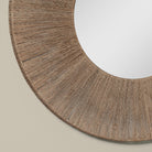 Close up of Highball Jute Round Mirror on a beige background at Addison West