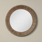 Collins Large Jute Mirror in Natural on a beige wall at Addison West