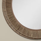 Close up of Collins Large Jute Mirror in Natural on a beige wall at Addison West