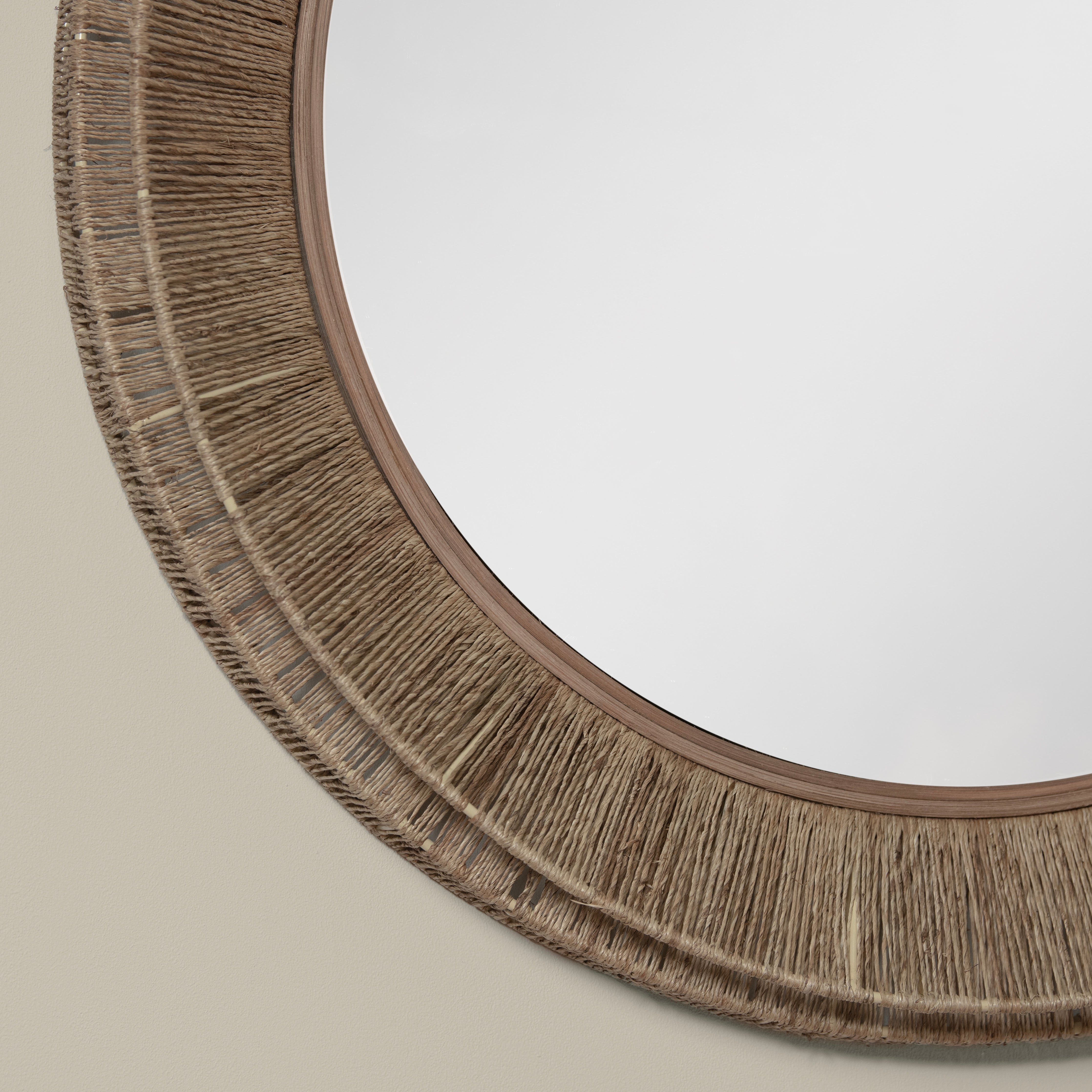 Close up of Collins Large Jute Mirror in Natural on a beige wall at Addison West