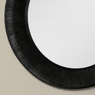 Close up of Collins Large Jute Mirror in Black on a beige wall at Addison West