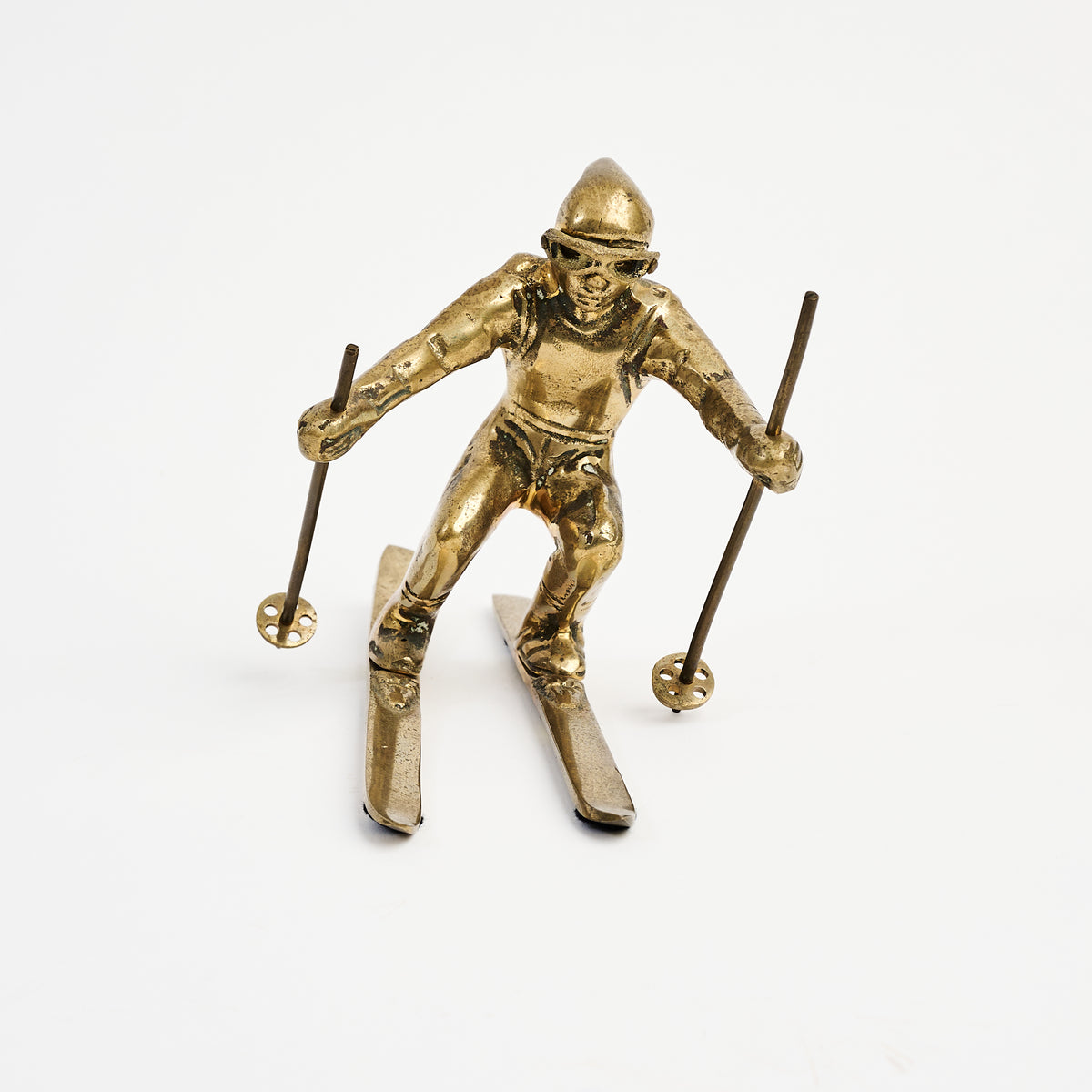 Vintage Brass Skier on a white background at Addison West