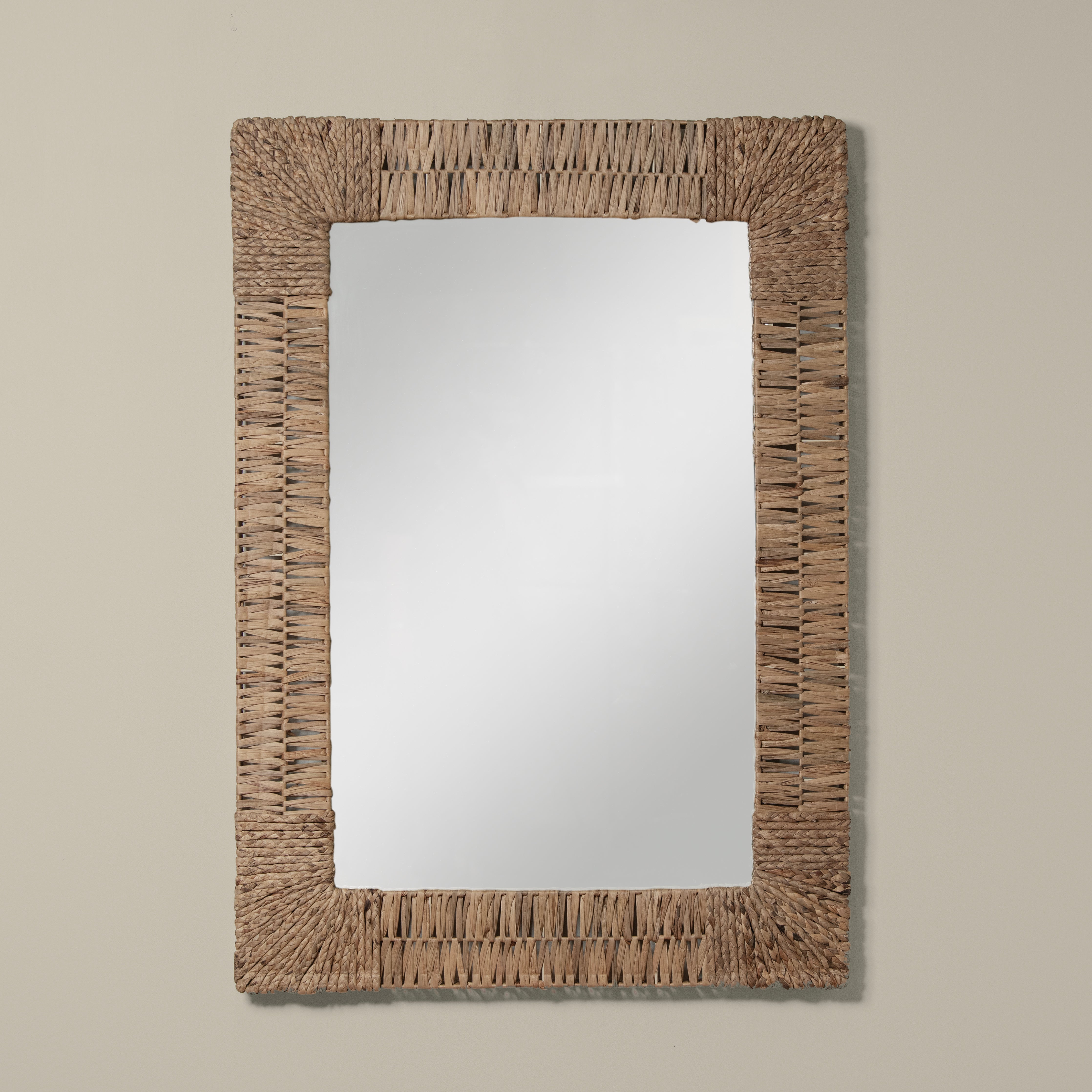 Folha Rectangular Mirror in Natural on a beige background at Addison West