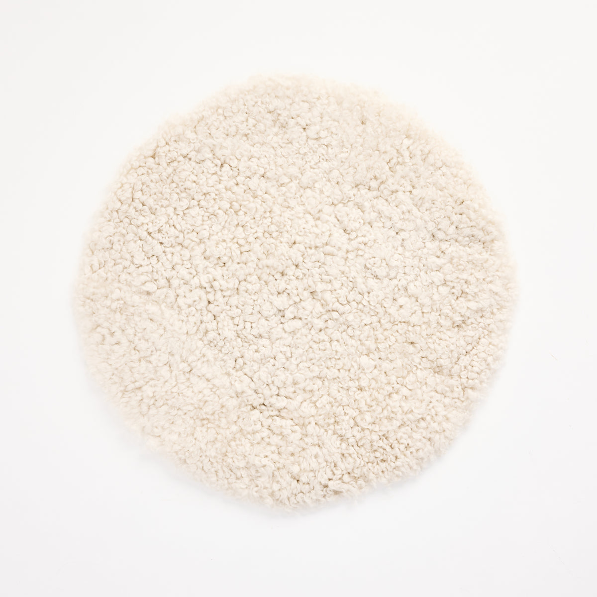 Short Wool Curly Sheepskin Seat Cover on a white background at Addison West