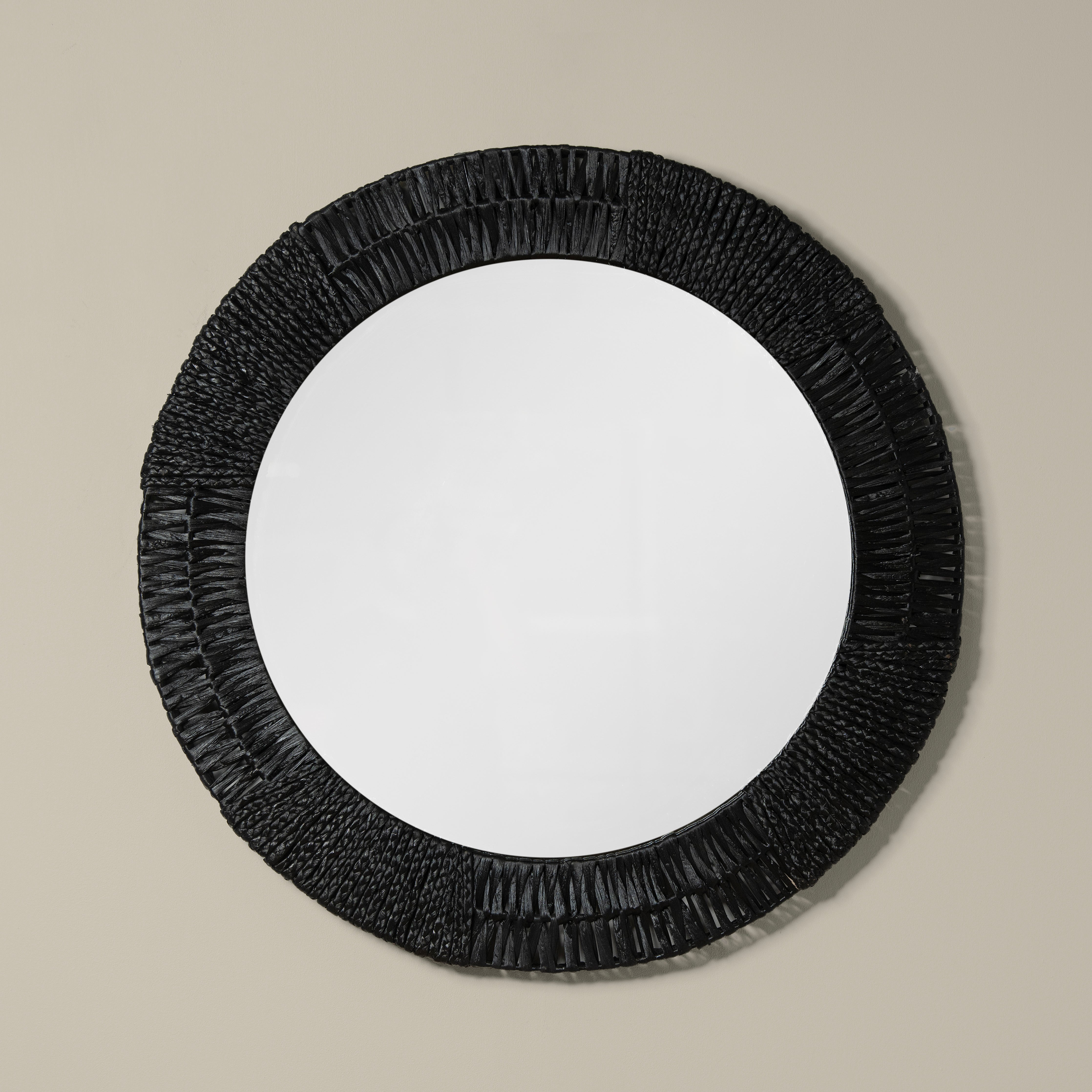 Folha Round Mirror in Black on a beige background at Addison West