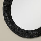 Close up of Folha Round Mirror in Black on a beige background at Addison West